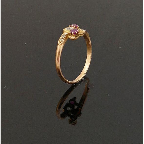 4 - A 19th century yellow metal ruby and diamond cross-over ring,  the central old-cut diamond approxima... 