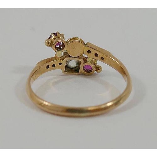 4 - A 19th century yellow metal ruby and diamond cross-over ring,  the central old-cut diamond approxima... 