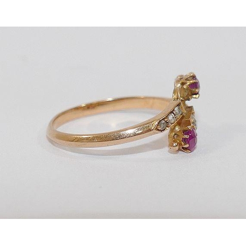 4 - A 19th century yellow metal ruby and diamond cross-over ring,  the central old-cut diamond approxima... 