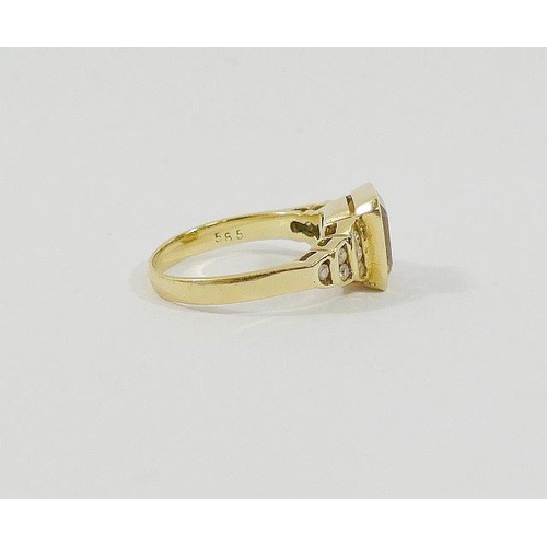 51 - A yellow metal citrine set dress ring, the central emerald-cut stone in rub-over setting, flanked by... 