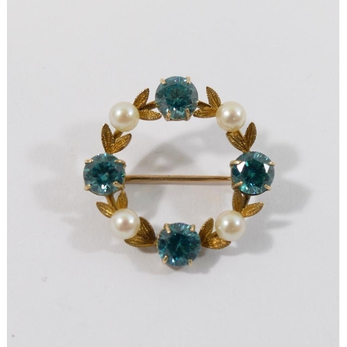 60 - A blue zircon and cultured pearl set wreath brooch, the stones interspersed with laurel leaves, unma... 