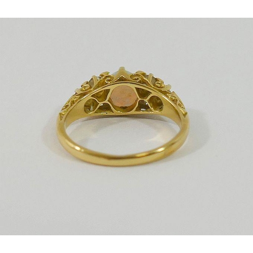 64 - An early 20th century 18 carat gold opal and diamond ring, the oval opal cabochon 7mm x 6mm x 3mm de... 