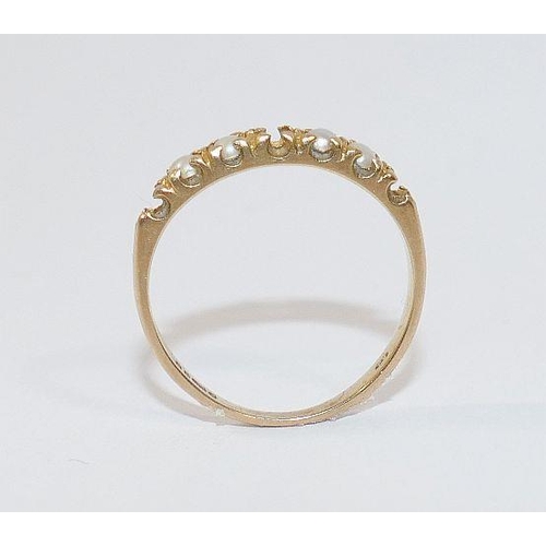 65 - A 9 carat gold split pearl set half eternity ring, London 1982, finger size N, 3 pearls lacking, 1.7... 