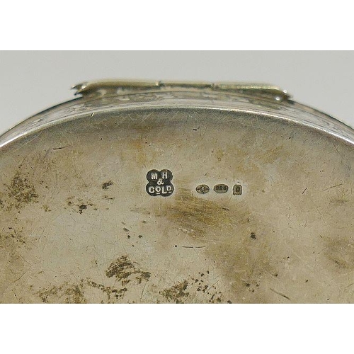 93 - An oval silver snuff box with import marks for London 1919, with gilt interior and floral decoration... 