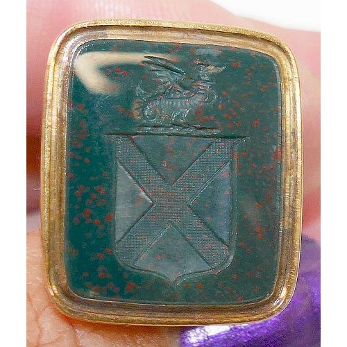 97 - A Georgian gold seal, set with bloodstone intaglio carved with Soltaire cross with Griffin surmount,... 