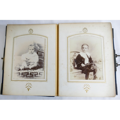 296A - A Victorian blue cloth and brass bound photograph album, complete with photos