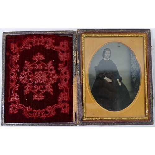 319A - Five 19th century ambrotypes featuring women and each housed within gilt metal mount and velvet surr... 