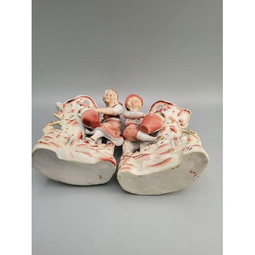 37 - Vintage Bisque porcelain spill vases featuring a boy and girl watering plants