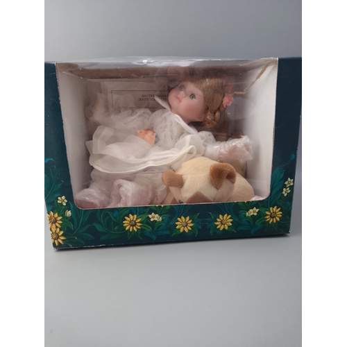150 - Musical doll in box with dog.