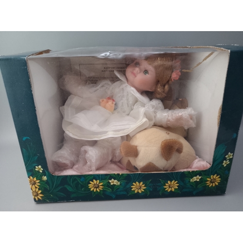 150 - Musical doll in box with dog.