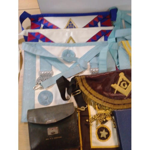 A collection of Masonic regalia, including aprons, collars, sashes ...