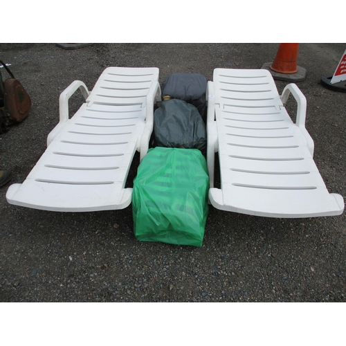 64 - A pair of PVC sun loungers complete with cushions