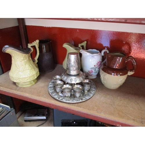 184 - A Denby Harvester jug, two relief moulded jugs and two others together with a silver plated wine sam... 