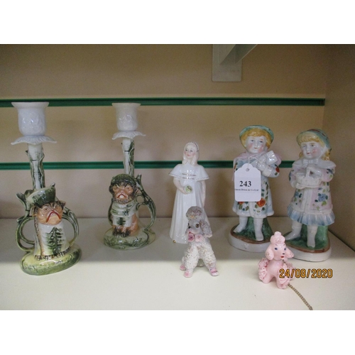 243 - Two ceramic candle sticks modelled in the form of pug dogs, two spagetti poodles, a Royal Doulton fi... 