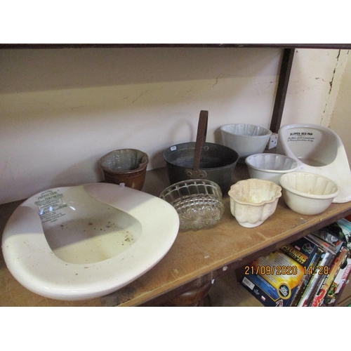 439 - A nineteenth century brass preserving pan, several vintage jelly moulds and two vintage bed pans