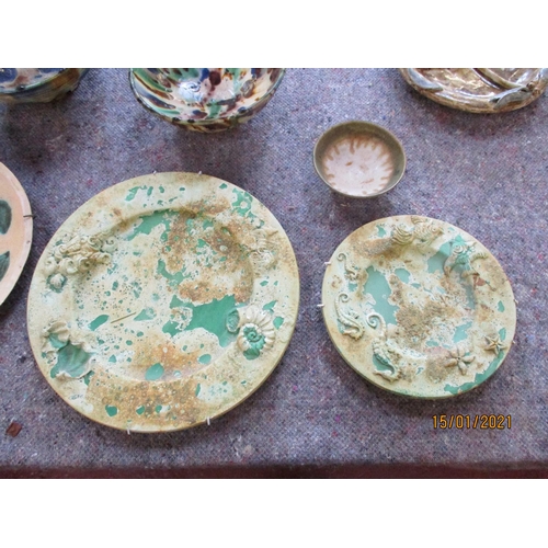 202 - Assorted pottery dishes together with a figure of the Madonna and child