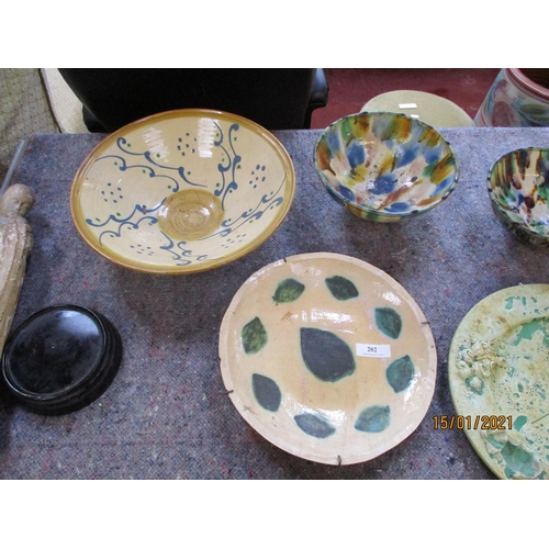 202 - Assorted pottery dishes together with a figure of the Madonna and child