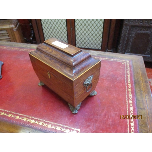 261 - A Regency kingwood rectangular tea casket with moulded top on four ormolou foliate and lions paw fee... 