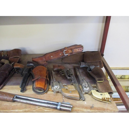 290 - A range of replica American Wild West revolvers and Winchester rifle, leather holsters and belts