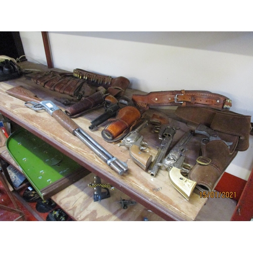 290 - A range of replica American Wild West revolvers and Winchester rifle, leather holsters and belts