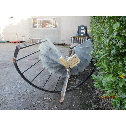 32 - A wrought iron and galvanised checker plate 12 tread exterior spiral staircase