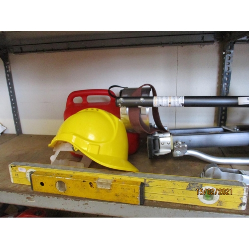 96 - A pair of plasterer's stilts together with a hard hat, a fuel can, two spirit levels etc.