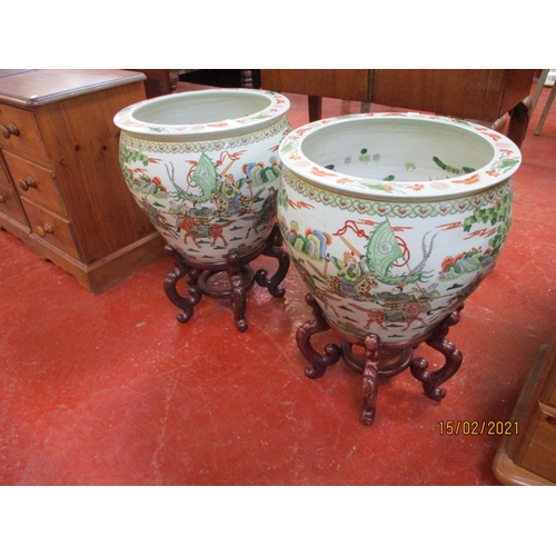 231 - A pair of oriental ceramic fish bowls on rosewood stands