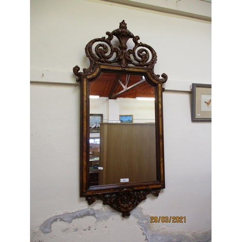 427 - An ornate mahogany framed wall mirror in the Regency style