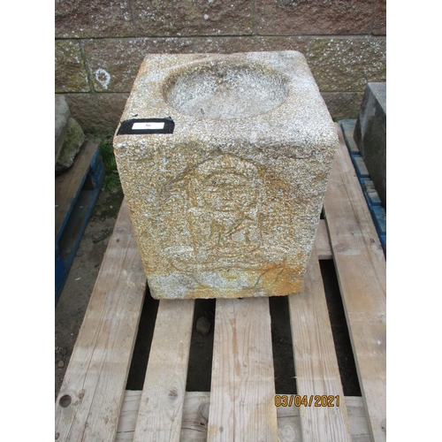 36 - A substantial well cut granite font with carved figural decoration