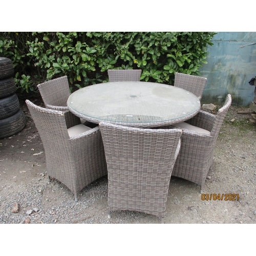 46 - An all weather rattan circular patio table together with six matching chairs