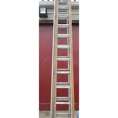 62 - An aluminium and wooden extension ladder together with two other aluminium ladders