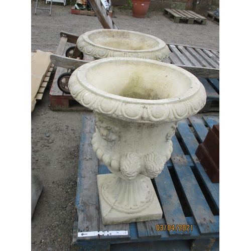 78 - A pair of reconstituted stone circular stemmed garden urns