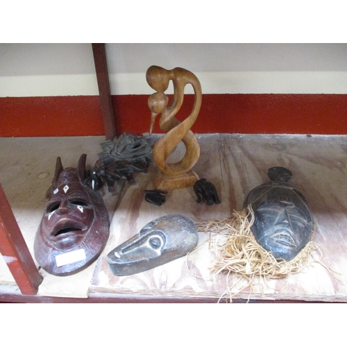 407 - A collection of ethnic face masks and other ethnic carved wooden models