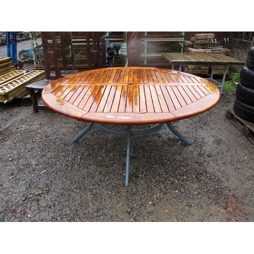 24 - A teak and metallic circular garden table