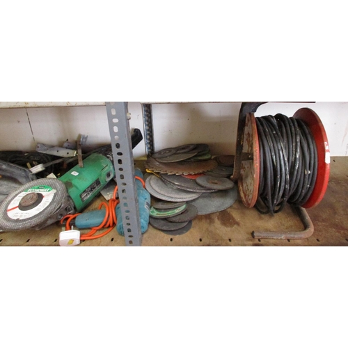 109 - Various power tools, cutting and grinding discs, an extension lead and reel