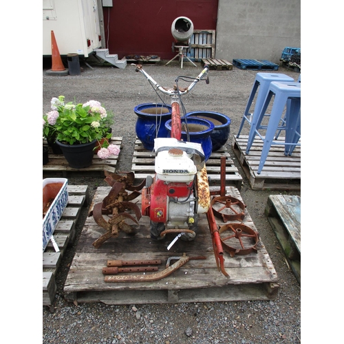 A Honda F400 garden cultivator complete with various