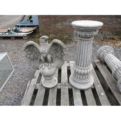 87 - A pair of reconstituted stone models of raptors on reeded pedestals