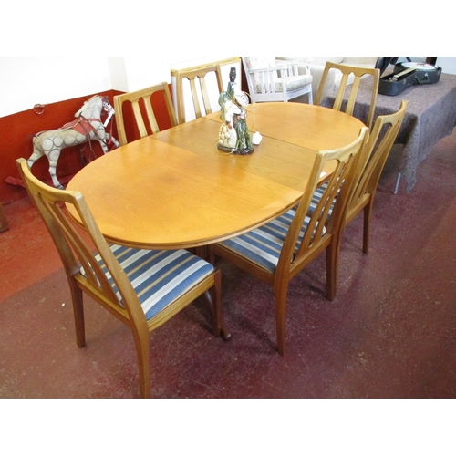 223 - A retro 1970s Parker Knoll extending teak dining table together with six matching chairs