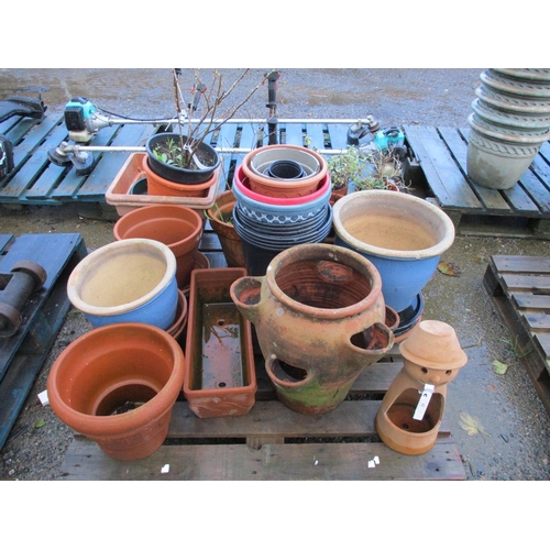62 - An assortment of terracotta garden pots, a strawberry pot and other planters