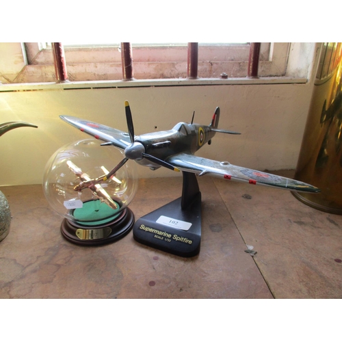 102 - A model of a Boeing B-17 in glass sphere together with a model of a Spitfire MK11