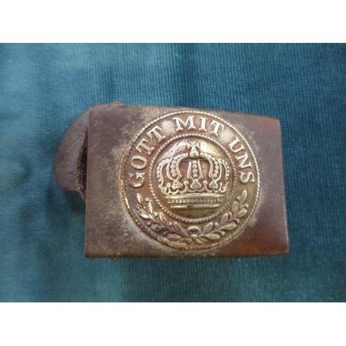 149 - Two military helmets, a German buckle and a vintage cleaning kit