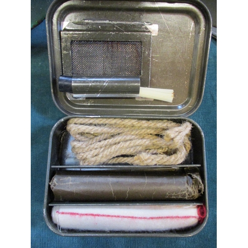 149 - Two military helmets, a German buckle and a vintage cleaning kit