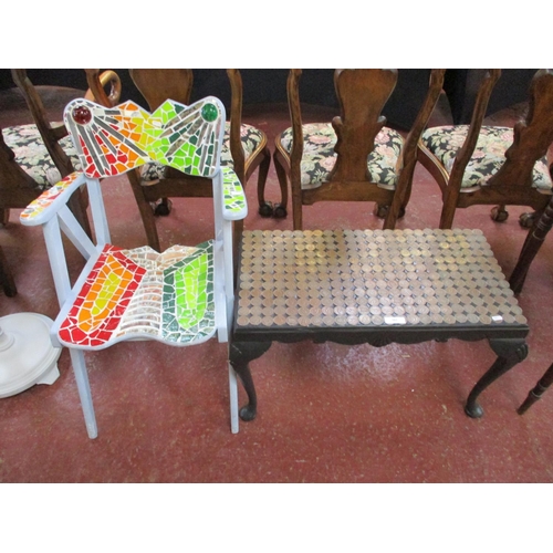 302 - A black finished rectangular coffee table with copper coinage decoration together with an open armch... 