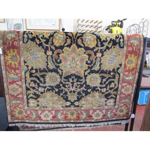 309 - An oriental floor rug on black ground with foliate decoration