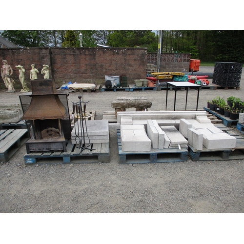 76 - A granite fireplace together with a cast iron fire and a companion set