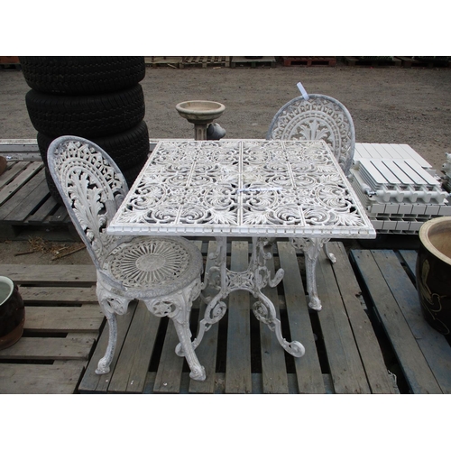 87 - A metallic garden table and two chairs all finished in white