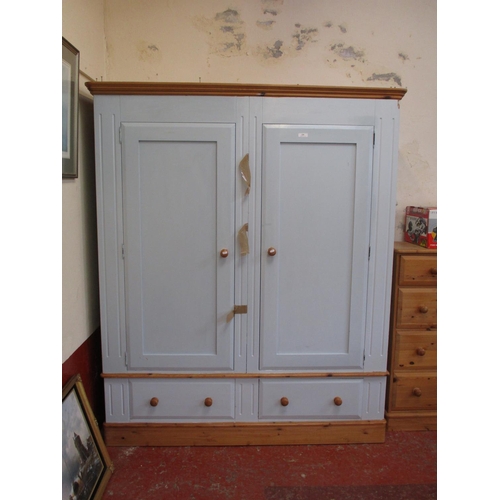 239 - A pine double wardrobe fitted two drawers below and finished in pale blue