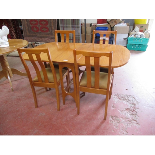 276 - An extending dining table with four chairs