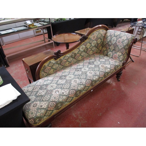 286 - A Victorian chaise longue upholstered in multi coloured fabric