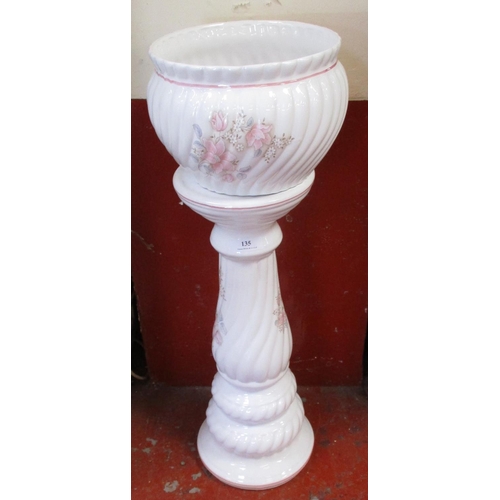 135 - A white ceramic jardinière with floral decoration